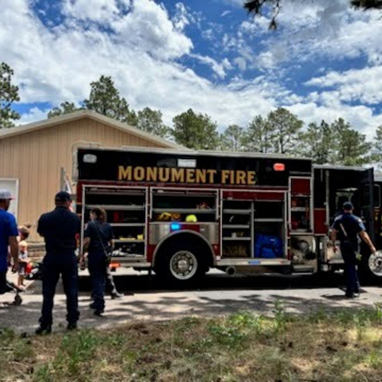 crowd gathered around the Monument fire truck