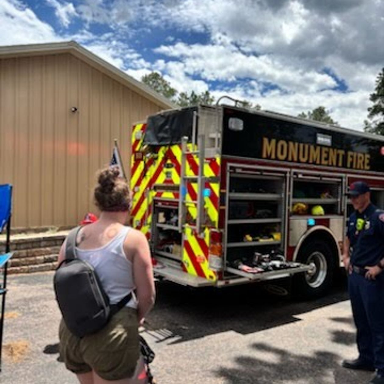 visitor with a stroller stopping by the Monument fire truck