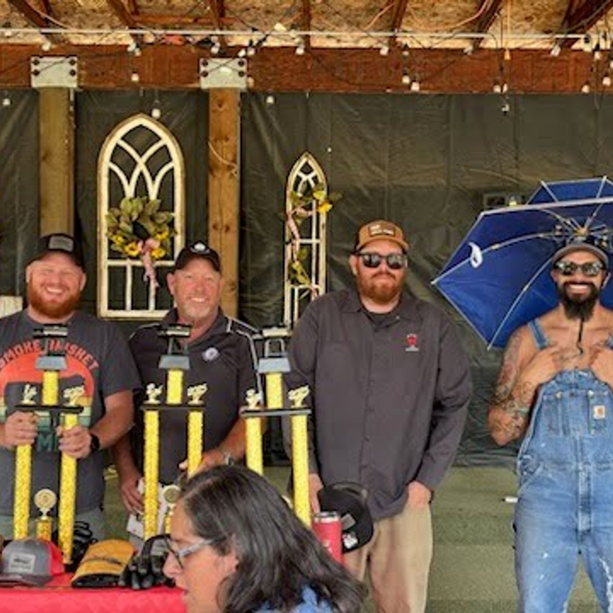 Smokin' Showdown trophies displayed with the event organizers